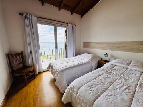 En eller flere senge i et værelse på Patagonien Alquiler Temporario