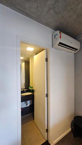 a hallway with a door to a bathroom with a heater at Studio espaço Bom Retiro in Sao Paulo