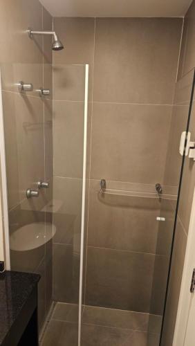 a shower with a glass door in a bathroom at Studio espaço Bom Retiro in Sao Paulo