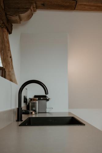 a kitchen counter with a sink in a kitchen at Molhemhoeve in Peer