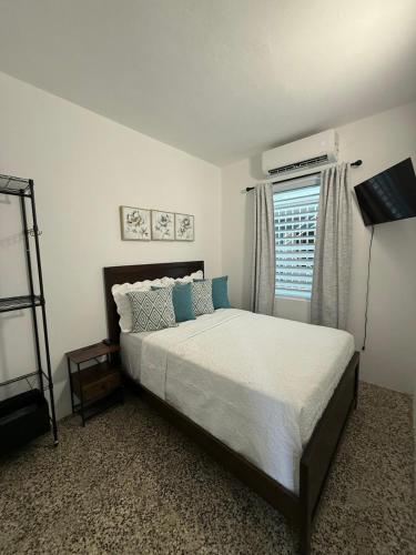 a bedroom with a large bed and a window at House with pool and close to everything in San Juan