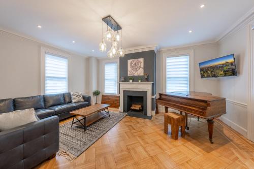 a living room with a couch and a piano at Casa Francesca 6BR Villa & Heated Pool in Roselle