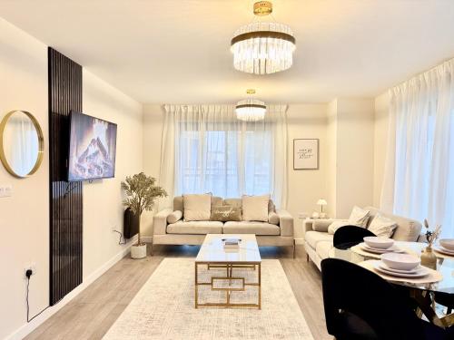 a living room with a couch and a table at Lux Stays - 2BR Leeds City Centre Apartment - Ground Floor with Free Parking in Leeds