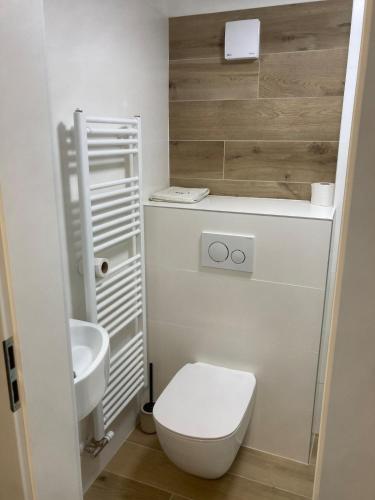 a small bathroom with a toilet and a sink at City center in Čadca