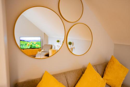 a living room with two mirrors above a couch at Location! Location! City Centre Townhouse Sleeps 6 in Galway