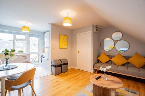 a living room with a couch and a table at Location! Location! City Centre Townhouse Sleeps 6 in Galway