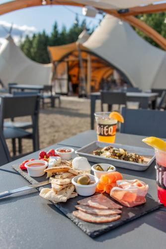 a table with a tray of food on a table at Under Canvas White Mountains in Dalton