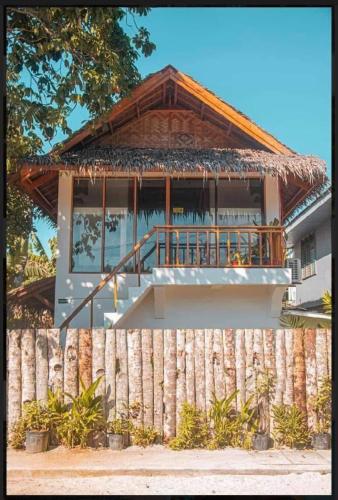 een huis met een hek ervoor bij Paradiso Hostel Siargao in General Luna