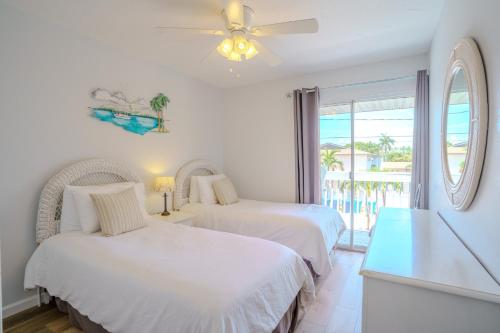 two beds in a room with a view of the ocean at 100' from the beach, Elegant 3BR Beach Retreat in Point O'Rocks