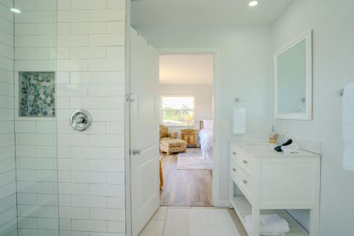 a white bathroom with a shower and a sink at 100' from the beach, Elegant 3BR Beach Retreat in Point O'Rocks