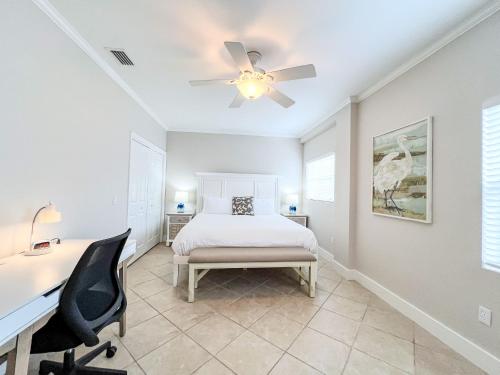 a bedroom with a bed and a desk and a ceiling fan at 100' from the beach, Charming 1BR Beachside Retreat in Point O'Rocks