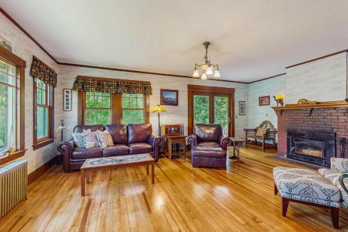 un soggiorno con mobili in pelle e un camino di Riverbank Manor a Moody