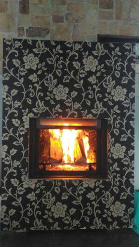 a fireplace against a black and white wall at Villa Flavina in San Vicente del Valle