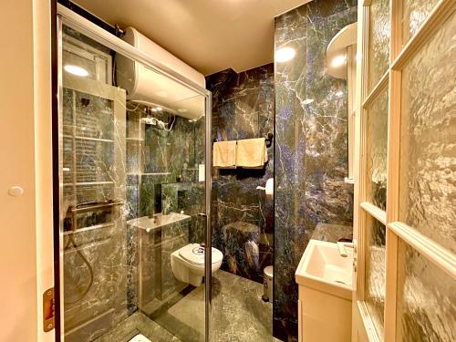 a bathroom with a shower and a toilet and a sink at Best apartments Narva in Narva