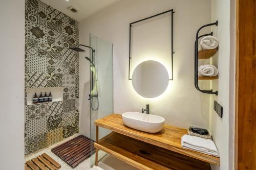 a bathroom with a sink and a shower at Wake Up in Nature - Serene Stays at Sarang Apartment 5 in Ubud in Ubud