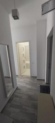 an empty hallway with two doors and a tile floor at MT Residential Studio in Roşu
