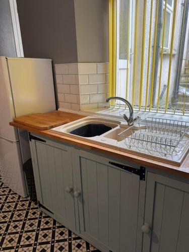 a kitchen counter with a sink and a window at Gaen - Ty Seren in Abertillery