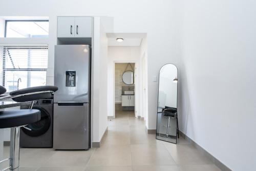 a bathroom with a washer and dryer in a room at Modern 2 Bed Home with Solar & Braai Langebaan in Langebaan