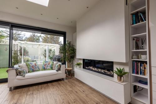 a living room with a couch and a fireplace at SWINTON HOUSE - Beautiful 3 Bed House in Harrogate, North Yorkshire in Harrogate