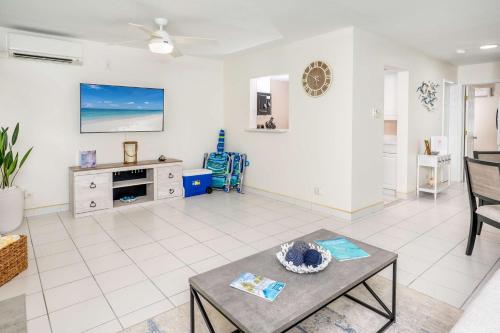 a living room with a table and a couch at Hideaway at Seagull #25 Condo in George Town
