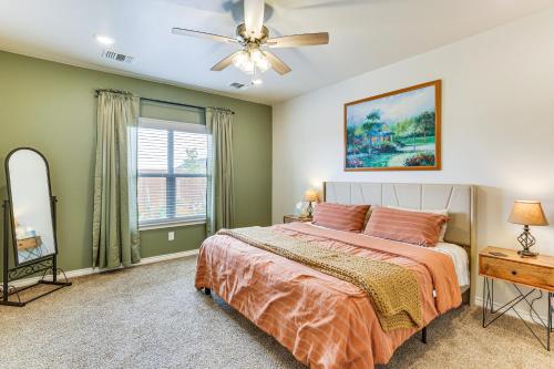 a bedroom with a bed and a ceiling fan at 11 Mi to Texas Tech University Cozy Family Home! in Wolfforth