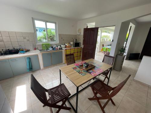a kitchen with a table and chairs in a room at Rayon des îles bien désiré in Saint-François