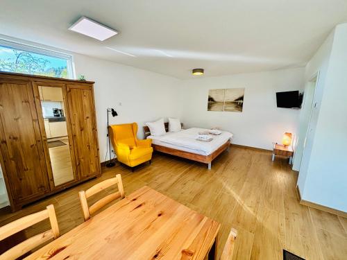 ein Schlafzimmer mit einem Bett und einem gelben Stuhl in der Unterkunft Erlebnisbad Badkap in 5 Minuten! in Albstadt