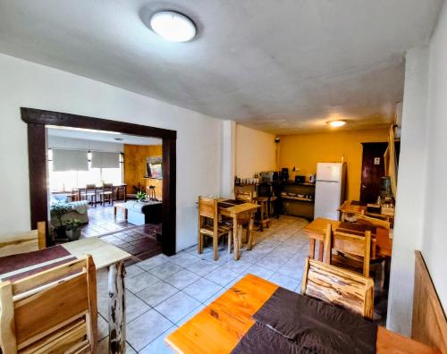 a kitchen and dining room with wooden tables and chairs at B&B Copahue in San Carlos de Bariloche
