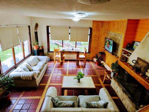 a large living room with couches and a table at B&B Copahue in San Carlos de Bariloche