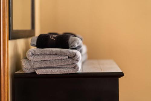 a pile of towels sitting on a table in a bathroom at Historic Midtown Apartment in Memphis