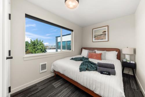 a bedroom with a bed and a large window at 2BR in Downtown with Parking in Spokane