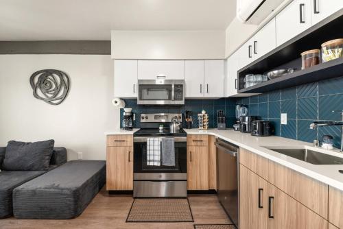 a kitchen with white cabinets and a stove top oven at 2BR Apartment in DT with Parking in Spokane