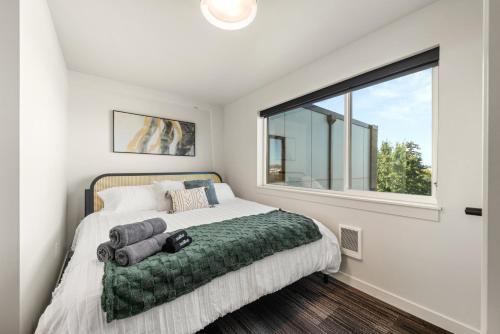 a bedroom with a bed and a large window at 2BR Apartment in DT with Parking in Spokane