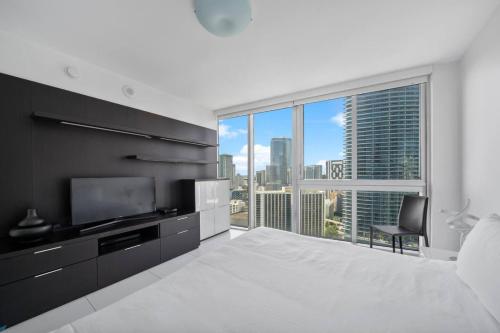 a bedroom with a large bed and a large window at W Miami - LUXURY condo Amazing Views in Miami