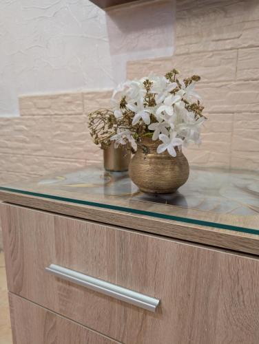 two vases with flowers on top of a counter at Pokoik Walentynka in Gniezno