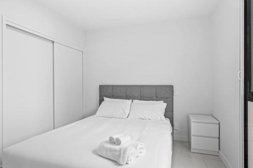 a bedroom with a bed with two towels on it at QV Stays Viaduct Harbour Elegance in Auckland
