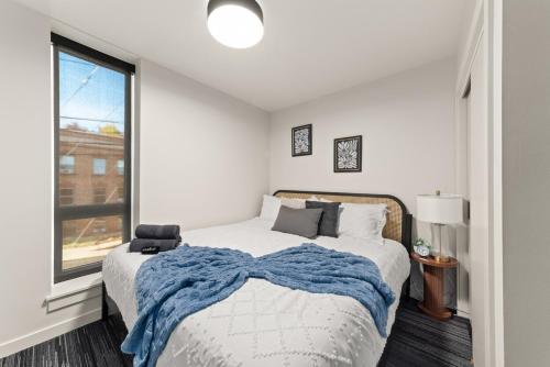 a bedroom with a bed with a blue blanket on it at Downtown 2br 1bath with Parking in Spokane