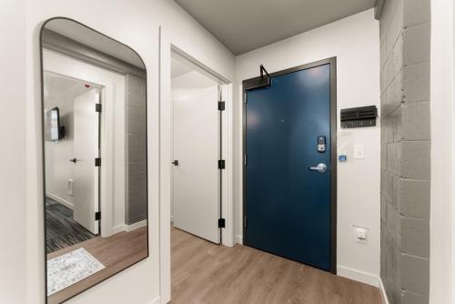 a blue door in a hallway with a mirror at Downtown 2br 1bath with Parking in Spokane