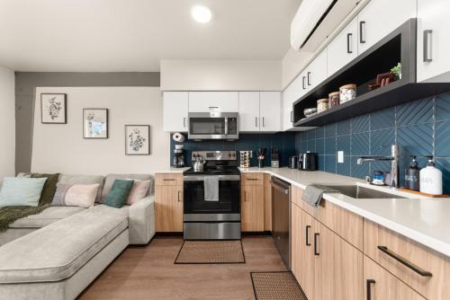 a living room with a couch and a kitchen at Downtown 2br 1bath with Parking in Spokane