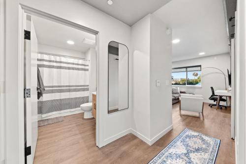 a white bathroom with a toilet and a table at DT 2br 2bath Modern Apartment in Spokane