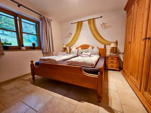 a bedroom with a bed with a wooden frame at Ferienwohnung Soiernseelig in Wallgau