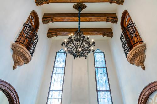 a chandelier hanging from a ceiling in a building with windows at Casa Castillo in Mexico City