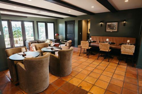 a restaurant with tables and chairs in a room at Casa Cody in Palm Springs