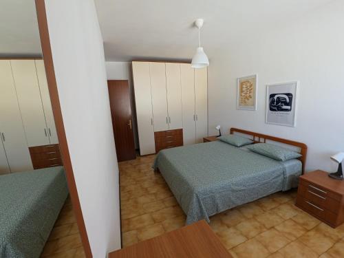 a bedroom with two beds and a mirror at Casa Giulia in Domodossola