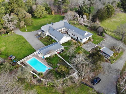 an aerial view of a house with a swimming pool at Rose Cottage in Puketapu