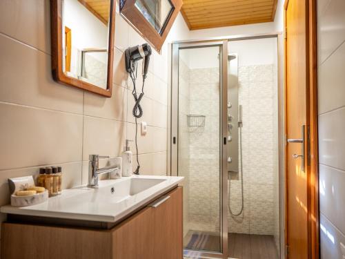 a bathroom with a sink and a shower at Villa Fontes 7 in Ponta Delgada