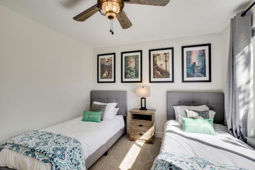 two beds in a bedroom with a ceiling fan at Mtn Bikers Escape! 7 Mi to Kokopelli Loops Trails in Fruita