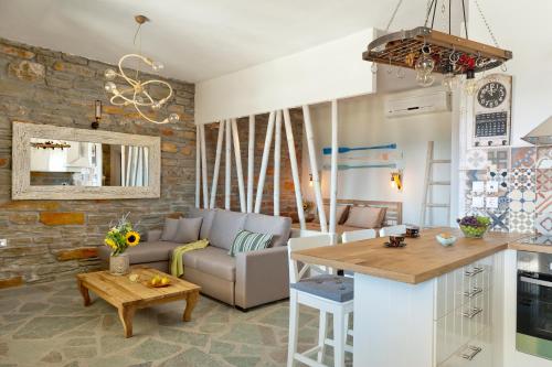 a kitchen and living room with a couch and a table at Sea & Stone Villas in Koundouros