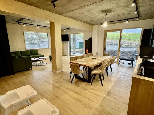 a dining room and living room with a table and chairs at Chalet Horizont in Ižipovce
