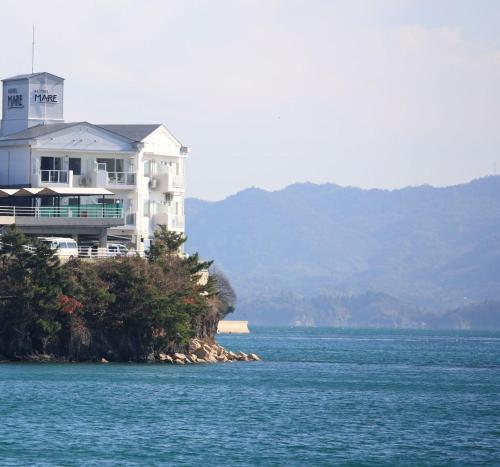 a large white house on an island in the water at Hotel Mare - Vacation STAY 59171v in Mitsuguchi